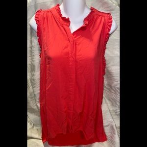Dark coral sleeveless top with ruffled edges.